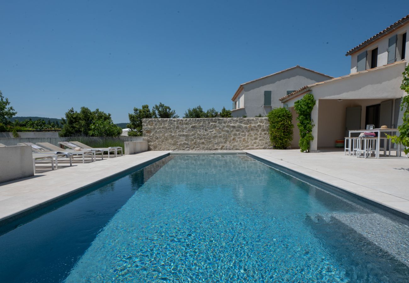 Piscine avec élégant escalier en béton et terrasses ensoleillées de chaque côté à la Villa Beaumont, Malaucène, Provence.