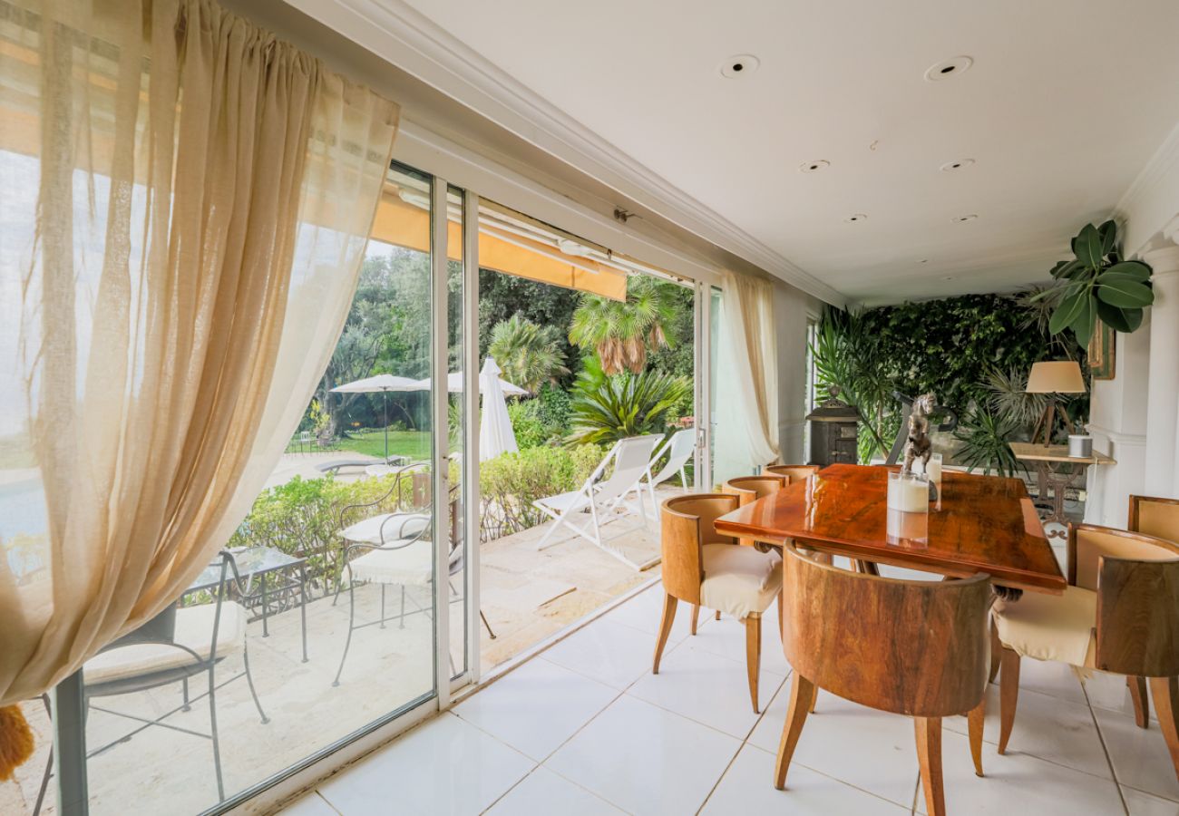 Another view of the dining area with a view of the swimming pool