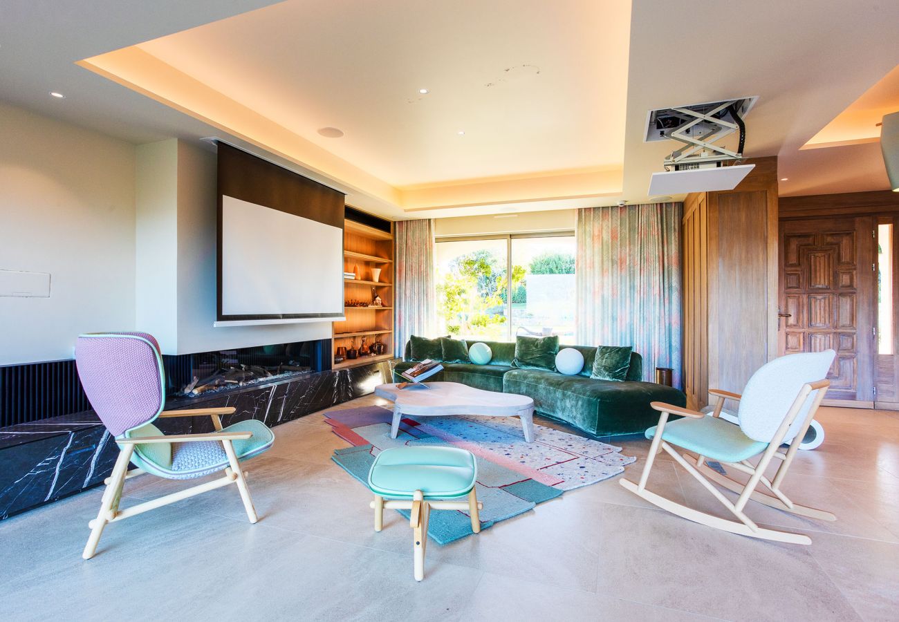 Living room with giant screen and fireplace