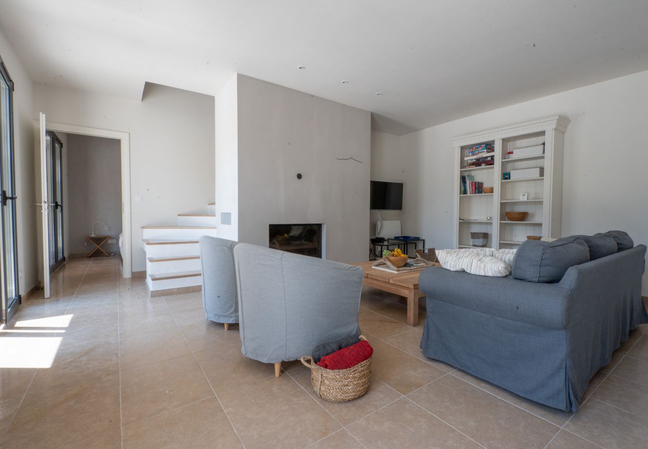 Comfortable sitting area by the fireplace in the living room of Villa Beaumont, located in Malaucène, Provence.